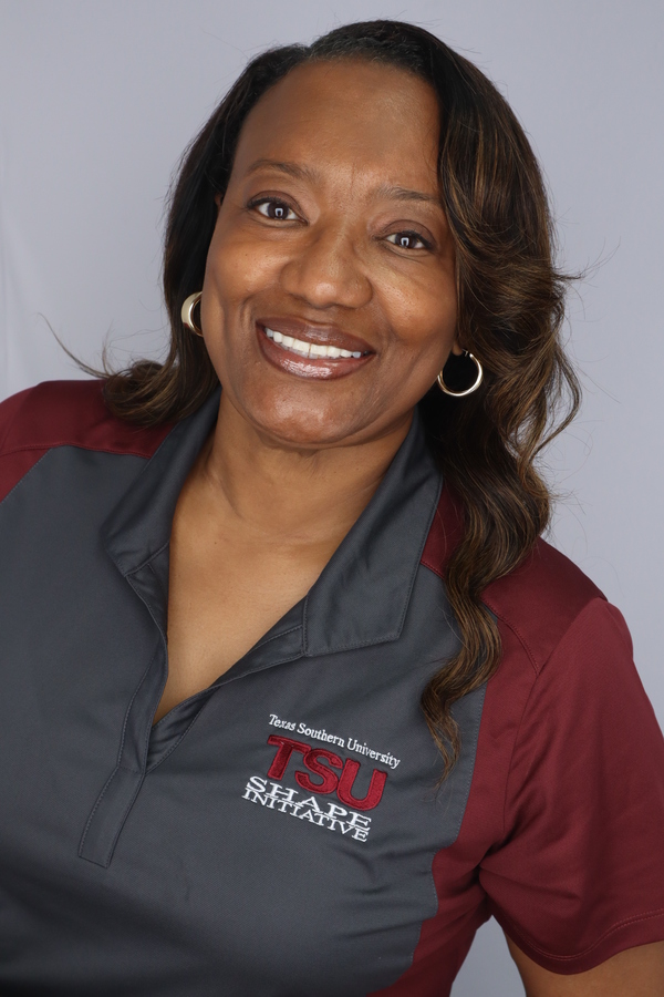 Brown skin woman with dark hair in a maroon and gray shirt.