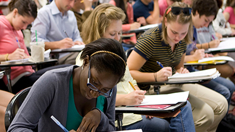 students writing at desks